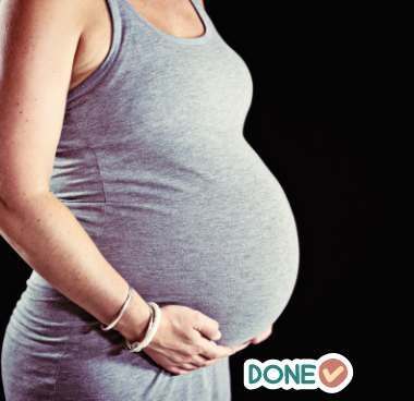 very pregnant woman with the word "done"