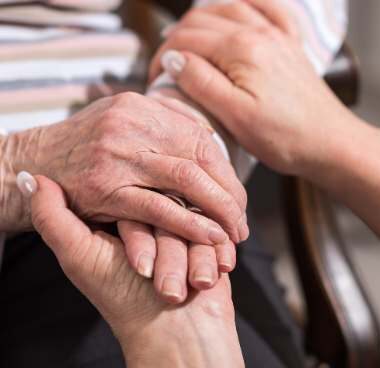 old woman and daughter holding hands