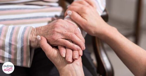 old woman and daughter holding hands