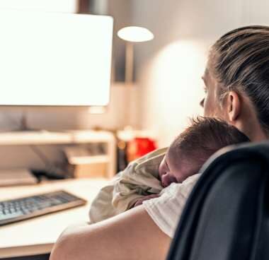 new mom looking at a computer screen