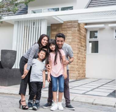 family in front of a home